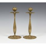 A pair of Art Nouveau cast ormolu candlesticks, each globular flowerhead nozzle above a petal drip