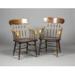 A pair of late Victorian Arts and Crafts style ash and elm spindle back elbow chairs, the shaped top