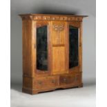 An Edwardian Arts and Crafts oak and copper mounted wardrobe by Shapland & Petter of Barnstaple, the