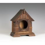 An early 20th century Arts and Crafts style oak architectural clock housing in the form of the