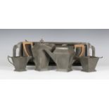 An early 20th century Arts and Crafts style pewter four-piece tea set and tray by 'Craftsman