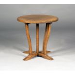 An early 20th century Arts and Crafts style oak circular occasional table, the chamfered top above