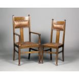 A set of five Edwardian Arts and Crafts oak framed dining chairs, comprising a carver and four