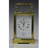 A 20th century French lacquered brass carriage alarm clock with eight day movement repeating on a