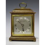 A late 20th century mahogany mantel timepiece by Elliott of London, the silvered dial with black