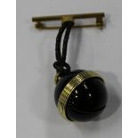 A Wyler gilt metal and black enamelled spherical pendant watch, the case front sliding to reveal the