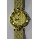 A Versace gilt metal circular cased quartz wristwatch, the decorated gilt dial with dot motifs,