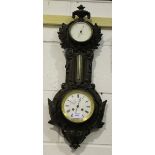 A Victorian cast iron cased wall clock, aneroid barometer and alcohol thermometer, the clock with