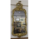 A 19th century Rococo Revival giltwood and gesso wall mirror with 'C' scrolls, ribbon swag and