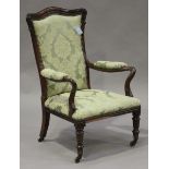 A Regency rosewood showframe library armchair, upholstered in a patterned light green damask, raised