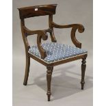 A modern William IV reproduction mahogany bar back elbow chair, upholstered in a patterned blue