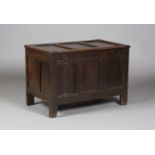 A late 17th century oak panelled coffer of narrow proportions, the interior fitted with a candle