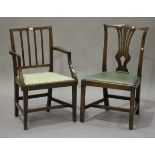 A George III Sheraton period mahogany comb back elbow chair, the drop-in seat upholstered in a