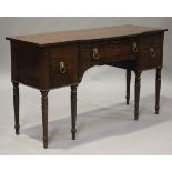 A George III mahogany breakfront sideboard with ebony stringing, fitted with three drawers, on