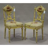 A pair of mid-Victorian giltwood and gesso salon chairs, the backs carved with wreath surmounts,