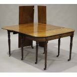 A 19th century mahogany extending dining table, the top with three extra leaves, raised on turned
