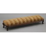 A Victorian walnut rectangular hearth stool, the upholstered top raised on carved cabriole legs,