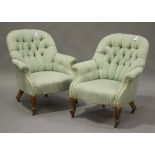 A pair of late Victorian tub back armchairs, upholstered in green striped fabric, raised on carved