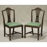 A set of six late 20th century reproduction mahogany dining chairs with green damask drop-in