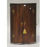 A George III oak bowfront hanging corner cabinet, height 94cm, width 62cm.Buyer’s Premium 29.4% (