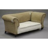 A late Victorian drop-end Chesterfield style settee, raised on mahogany legs and china castors,