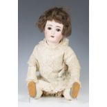 An Alt Beck Gottschalk bisque head doll, impressed '1362 3.11', with brown wig, closing brown