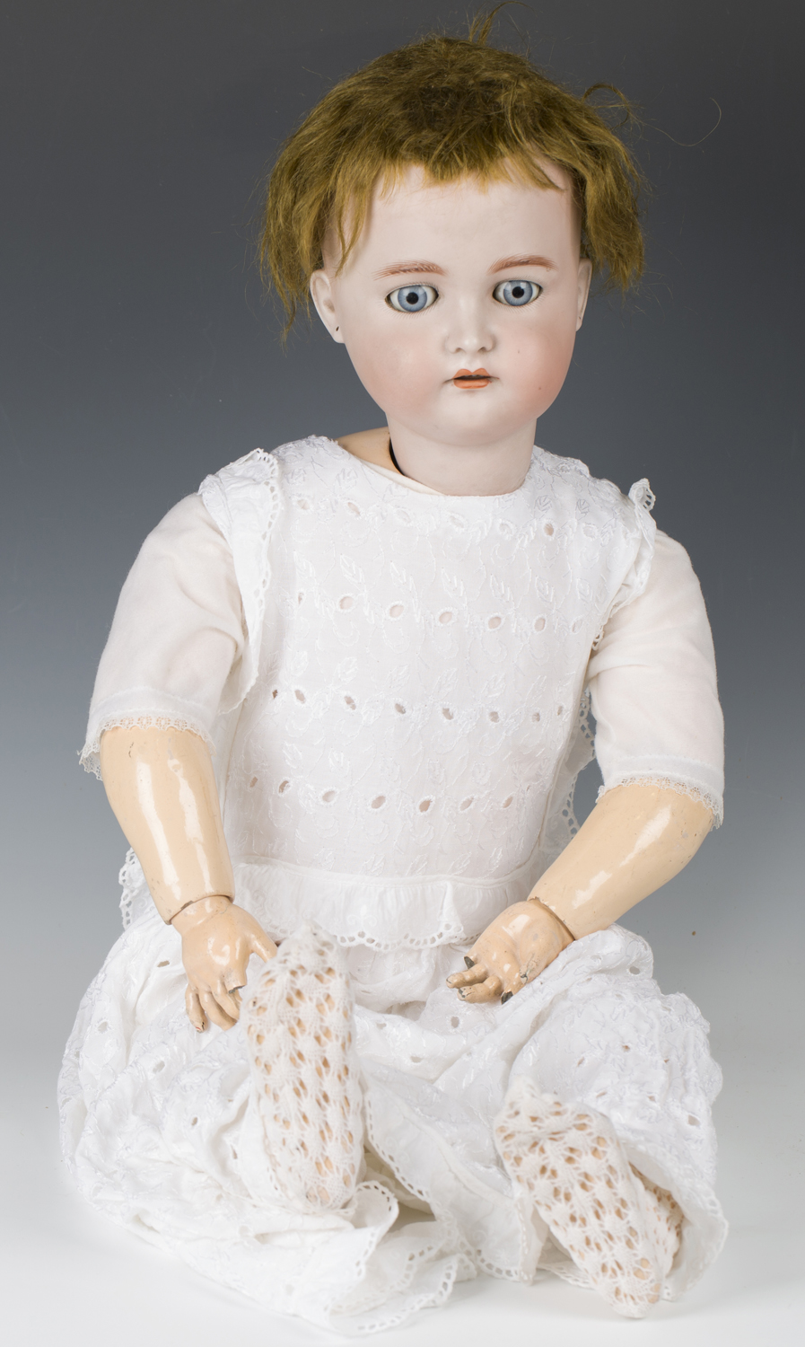 A Simon & Halbig K&R bisque head doll, impressed '80', with brown wig, pierced ears, sleeping blue