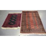 A Pakistan bokhara rug, late 20th century, the pink field with two columns of guls, within a