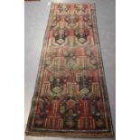 An Afghan/Beluche runner, early/mid-20th century, the charcoal field with overall bands of