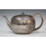 A late Victorian silver teapot of compressed circular form, the body chased and engraved with a