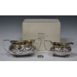 A George III silver cream jug and two-handled sugar bowl, each of cushion form with gadrooned rim,