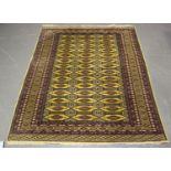 A Pakistan bokhara rug, late 20th century, the mustard coloured field with three columns of guls,