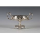 A George V silver comport, the shallow circular bowl with gadrooned rim and stylized leaf and scroll