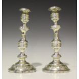 A pair of George III silver candlesticks with detachable nozzles, each baluster stem decorated in