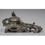 A late 19th century Continental plated inkstand of rococo scroll form, the rim cast as the head