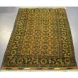 An Afghan rug, mid-20th century, the golden yellow field with an overall lattice of flowerheads,