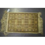 A Turkish silk mat, late 20th century, the ivory field with three geometric medallions, within a