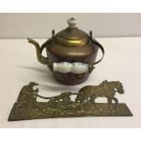 A vintage brass kettle with ceramic handle and finial together with a brass plaque of a farmer and