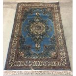 A Turkish rug in blue and cream colouration. Approx 121 x 188cm.