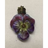 A small vintage ceramic scent bottle in the shape of a viola flower. With bale attached for use as a