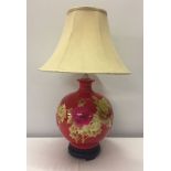 A large red ceramic oriental table lamp with fine marquetry decoration.Vendor advises perfect