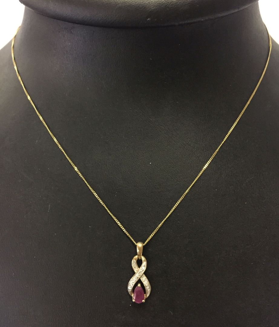 9ct gold ruby and diamond pendant on a 9ct gold chain. Total weight approx 1.4g.