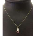 9ct gold ruby and diamond pendant on a 9ct gold chain. Total weight approx 1.4g.