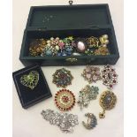 A large quantity of stone set costume jewellery brooches.