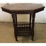 An octagonal topped occasional table with gallery style under tray, on china casters. Approx 73 x