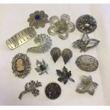 A collection of costume brooches to include filigree & marcasite.