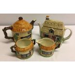 A 3 piece Beswick cottage ware teaset together with a modern teapot from 'The Village' teapot