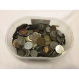 A tub of various world coins.