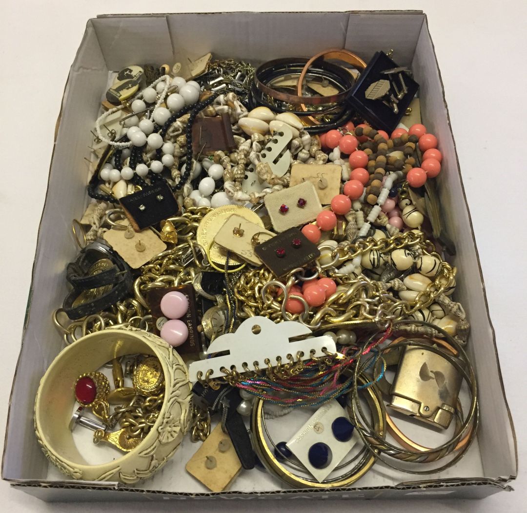 A box of modern and vintage costume jewellery plus badges, watches and a lighter.