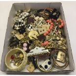 A box of modern and vintage costume jewellery plus badges, watches and a lighter.